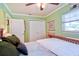 Well-lit bedroom features a ceiling fan, closet, window, and a comfortable bed at 6912 14Th N St # 6912, St Petersburg, FL 33702