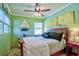 A cozy bedroom features a ceiling fan, nautical decorations, and soft lighting for a relaxing ambiance at 6912 14Th N St # 6912, St Petersburg, FL 33702