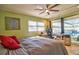Bedroom featuring pool view through sliding doors and a dedicated office space, seamlessly blending work and relaxation at 6912 14Th N St # 6912, St Petersburg, FL 33702