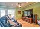 Comfortable living room featuring a large screen TV, leather seating, and entertainment setup at 6912 14Th N St # 6912, St Petersburg, FL 33702