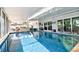 Indoor pool with a swim-up bar and outdoor seating, perfect for entertaining and relaxation at 6912 14Th N St # 6912, St Petersburg, FL 33702