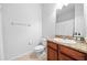 Well-lit bathroom featuring granite counters, and a sink with wood cabinetry at 7001 Interbay Blvd # 192, Tampa, FL 33616