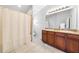 Bathroom with double vanity, granite counters, tile floor, and shower at 7001 Interbay Blvd # 192, Tampa, FL 33616