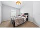 Comfortable bedroom with neutral carpet, decorative light fixture, and large window at 7001 Interbay Blvd # 192, Tampa, FL 33616