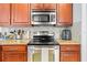 Well-equipped kitchen with stainless steel appliances, granite countertops, and wood cabinets at 7001 Interbay Blvd # 192, Tampa, FL 33616