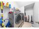 Well-equipped laundry room with front load washer, dryer, shelving and tile flooring at 7001 Interbay Blvd # 192, Tampa, FL 33616