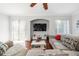 Comfortable living room with hardwood floors, a large TV, and plenty of natural light at 7001 Interbay Blvd # 192, Tampa, FL 33616