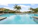 Community pool with blue water, lounge chairs, and palm trees at 7001 Interbay Blvd # 192, Tampa, FL 33616