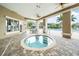 Outdoor hot tub with surrounding seating, pool, and landscaping at 7001 Interbay Blvd # 192, Tampa, FL 33616
