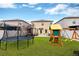 Spacious backyard featuring a trampoline, a playset, and lots of room to run around at 7017 Gomez Rocks Ct, Sun City Center, FL 33573