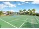 Outdoor basketball court in a fenced area with palm trees, offering an active recreation opportunity within the community at 7017 Gomez Rocks Ct, Sun City Center, FL 33573
