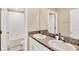 Bathroom with a double sink vanity, granite countertop and a shower-tub combo at 7017 Gomez Rocks Ct, Sun City Center, FL 33573