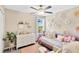 Bedroom with a pink toddler bed, floral decorations and a ceiling fan with light fixture at 7017 Gomez Rocks Ct, Sun City Center, FL 33573