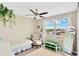 Bright bedroom with large window and a cozy chair with ottoman at 7017 Gomez Rocks Ct, Sun City Center, FL 33573