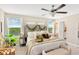 Bedroom featuring a neutral palette, natural light, and a decorative headboard with greenery at 7017 Gomez Rocks Ct, Sun City Center, FL 33573