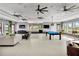 Clubhouse featuring a pool table, ample seating and several large windows at 7017 Gomez Rocks Ct, Sun City Center, FL 33573