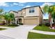 Inviting two-story home with a well-manicured lawn, a neutral color scheme, and an attached two-car garage at 7017 Gomez Rocks Ct, Sun City Center, FL 33573