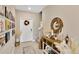 Elegant foyer with a console table, decorative mirror, and a gallery wall of Gathering photos at 7017 Gomez Rocks Ct, Sun City Center, FL 33573