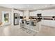 Bright kitchen with white cabinets, granite countertops, stainless appliances, and a large island at 7017 Gomez Rocks Ct, Sun City Center, FL 33573