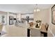 Open-concept kitchen and dining area with white cabinets, stainless appliances, and granite countertops at 7017 Gomez Rocks Ct, Sun City Center, FL 33573