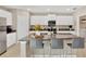 Lovely kitchen with a spacious island, granite counters, white cabinets, and stainless appliances at 7017 Gomez Rocks Ct, Sun City Center, FL 33573