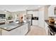 Charming open kitchen featuring granite counters, white cabinets, and stainless steel appliances at 7017 Gomez Rocks Ct, Sun City Center, FL 33573