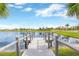 Scenic lake view featuring a wooden pier with grey railing in a lush community on a bright day at 7017 Gomez Rocks Ct, Sun City Center, FL 33573