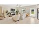 Bright living room featuring a white sofa, fireplace, and neutral decor at 7017 Gomez Rocks Ct, Ruskin, FL 33573