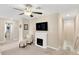 Inviting loft area with a cozy fireplace, plush chair, and nearby access to stairs and a hallway at 7017 Gomez Rocks Ct, Sun City Center, FL 33573