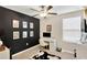 Stylish office with a bold black accent wall, modern desk setup, and unique decorative elements at 7017 Gomez Rocks Ct, Ruskin, FL 33573