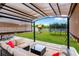 Relaxing covered patio featuring comfortable seating, a coffee table, and a view of the backyard at 7017 Gomez Rocks Ct, Sun City Center, FL 33573