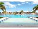 Resort-style pool with shallow entry, palm trees, lounge seating, and a covered gazebo for a relaxing outdoor experience at 7017 Gomez Rocks Ct, Sun City Center, FL 33573