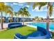 Inviting pool area with shady cabanas and comfortable lounge seating offers a relaxing and luxurious outdoor experience at 7017 Gomez Rocks Ct, Sun City Center, FL 33573
