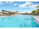 Large community pool featuring a splash pad, covered gazebo, and plenty of seating, perfect for Gathering fun and relaxation at 7017 Gomez Rocks Ct, Sun City Center, FL 33573