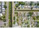 Birds eye view of homes featuring pools, solar panels, and canal access within a tranquil community at 7676 18Th St N, St Petersburg, FL 33702