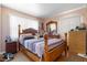 Cozy bedroom features a wooden four-poster bed with striped bedding and bright natural light at 7676 18Th St N, St Petersburg, FL 33702