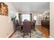 Formal dining area with leather chairs, stylish area rug, and views through a pass-through into the living room at 7676 18Th St N, St Petersburg, FL 33702