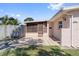 Exterior view of a single-Gathering home with a small front patio area and well-maintained lawn and foliage at 7676 18Th St N, St Petersburg, FL 33702