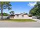 Charming single-story home featuring a quaint screened porch and classic Florida architecture under a clear blue sky at 7676 18Th St N, St Petersburg, FL 33702
