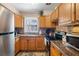 Well-equipped kitchen featuring wooden cabinets, granite countertops, and stainless steel appliances, ready for culinary adventures at 7676 18Th St N, St Petersburg, FL 33702