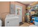 Laundry room with washer, dryer, shelving, storage, and a door leading to the exterior of the home at 7676 18Th St N, St Petersburg, FL 33702