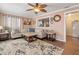 Comfortable living room with neutral tones, an area rug, and a pass-through window for an open feel at 7676 18Th St N, St Petersburg, FL 33702