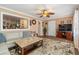 Cozy living room with stylish decor, a ceiling fan, and a pass-through window to another room at 7676 18Th St N, St Petersburg, FL 33702