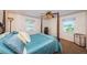 Cozy bedroom with a four-poster bed, soft bedding, and natural light from two windows at 841 4Th N Ave # 21, St Petersburg, FL 33701