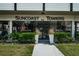 Entrance to Suncoast Towers featuring glass doors, manicured bushes, and signage at 841 4Th N Ave # 21, St Petersburg, FL 33701