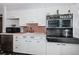 Nostalgic kitchen showcasing vintage appliances, pristine white cabinetry and a classic black and white tile floor at 841 4Th N Ave # 21, St Petersburg, FL 33701