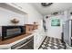A vintage kitchen featuring white cabinets, unique black and white patterned tile floor and stainless steel appliances at 841 4Th N Ave # 21, St Petersburg, FL 33701