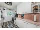 Charming kitchen with retro pink tile accents, white cabinets and stainless steel refrigerator at 841 4Th N Ave # 21, St Petersburg, FL 33701
