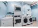 Well-lit laundry room featuring multiple washers and dryers, offering convenience and ample laundry space at 841 4Th N Ave # 21, St Petersburg, FL 33701