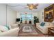 Traditional-style living room featuring comfortable seating, a ceiling fan, and a large window at 841 4Th N Ave # 21, St Petersburg, FL 33701
